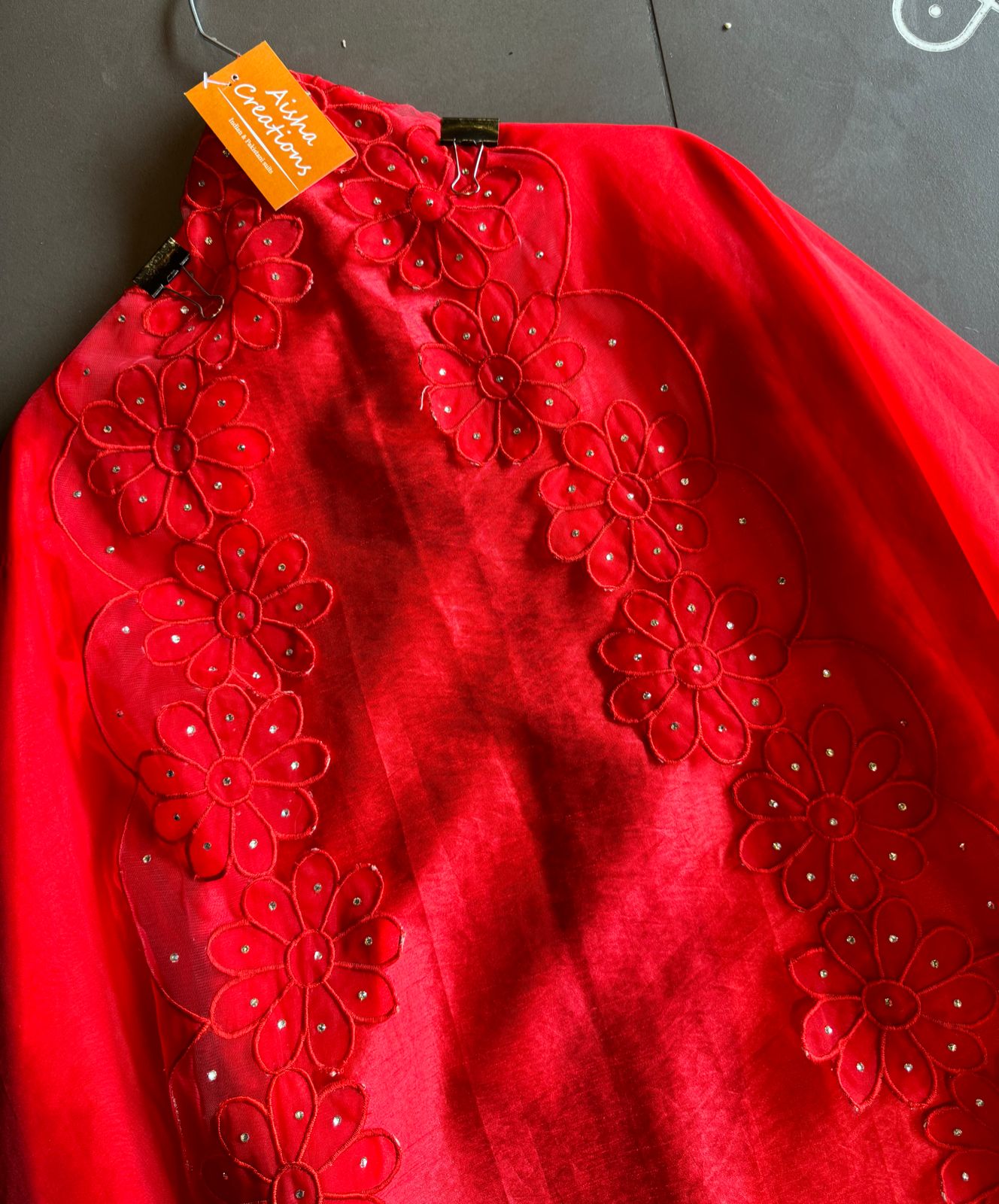 Red in colour With very smart Cutwork flower design with stone work highlighting.