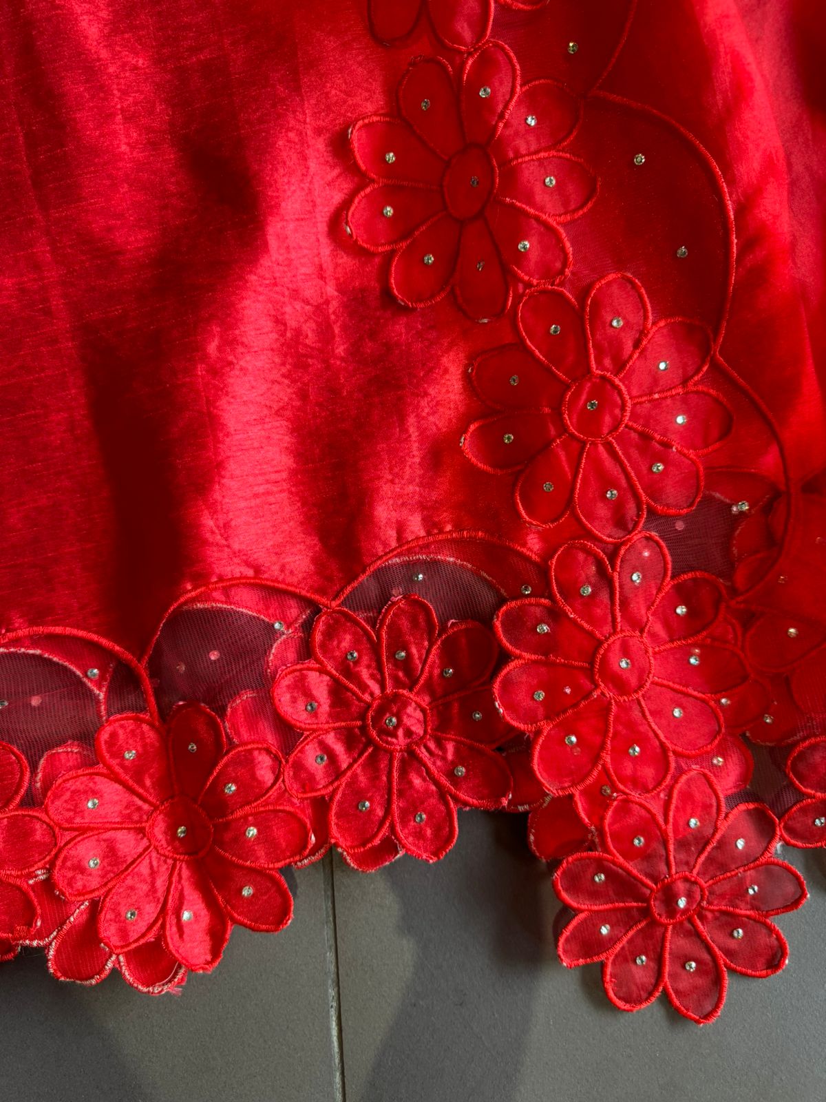Red in colour With very smart Cutwork flower design with stone work highlighting.