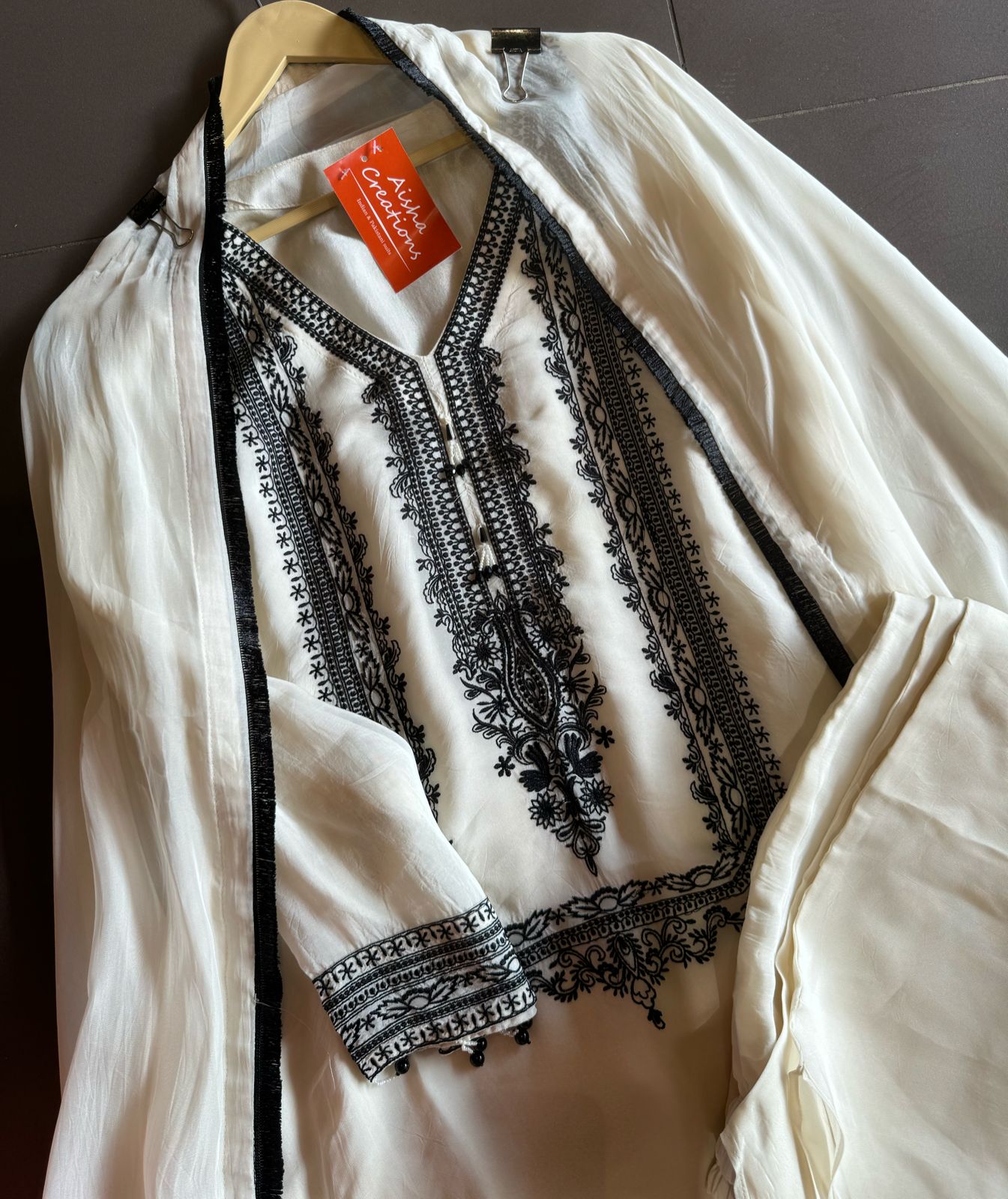 Soft flowy organza shirt with very smart and elegant thread work done on the neckline