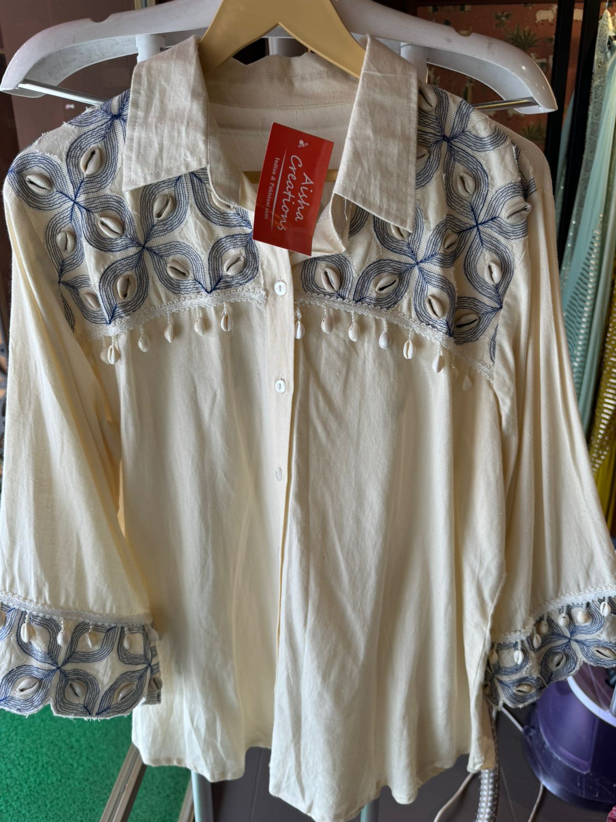 It has cotton Cutwork applique work on the shoulder and sleeves and back with shankh Beads attached