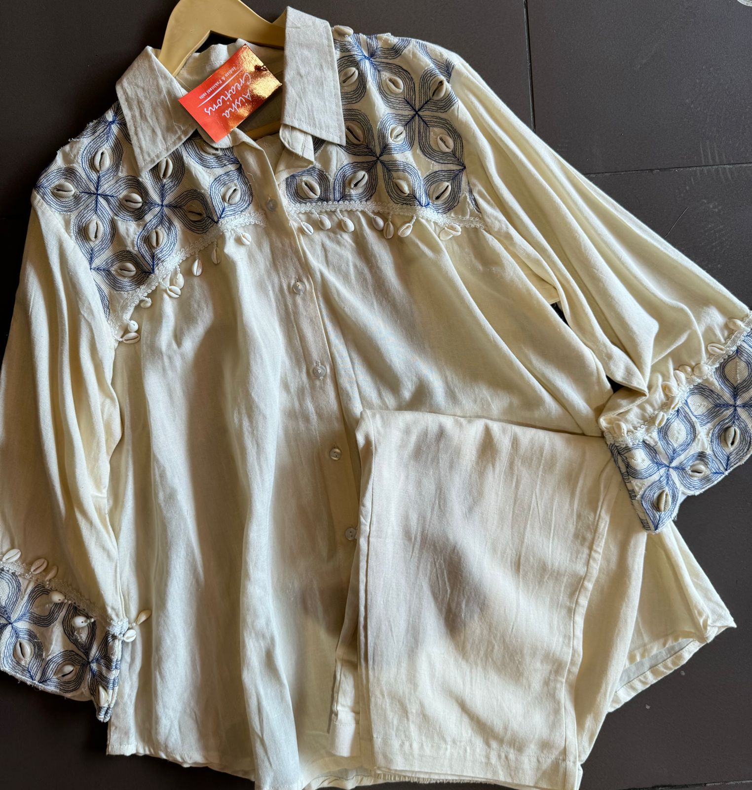 It has cotton Cutwork applique work on the shoulder and sleeves and back with shankh Beads attached