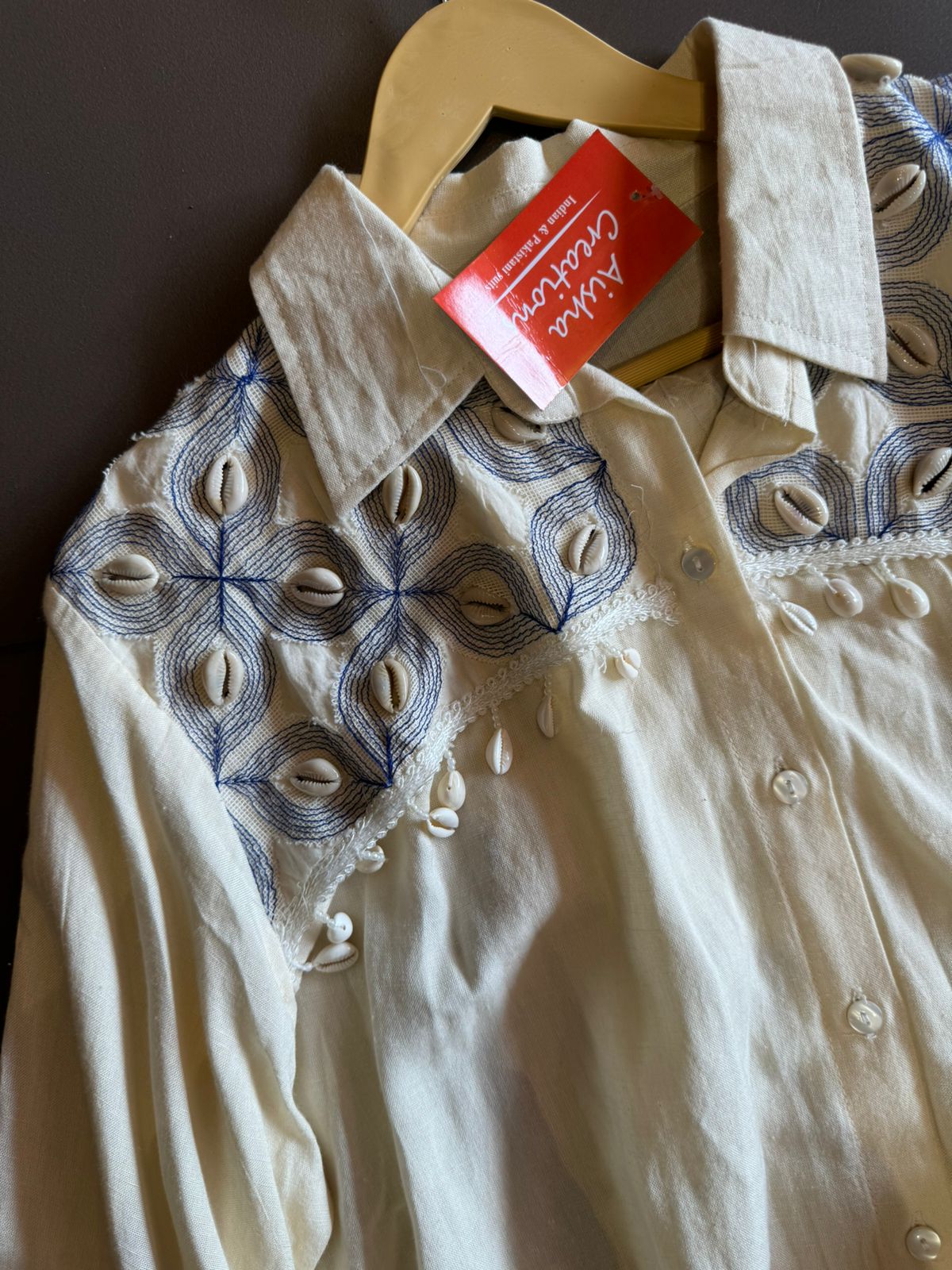 It has cotton Cutwork applique work on the shoulder and sleeves and back with shankh Beads attached