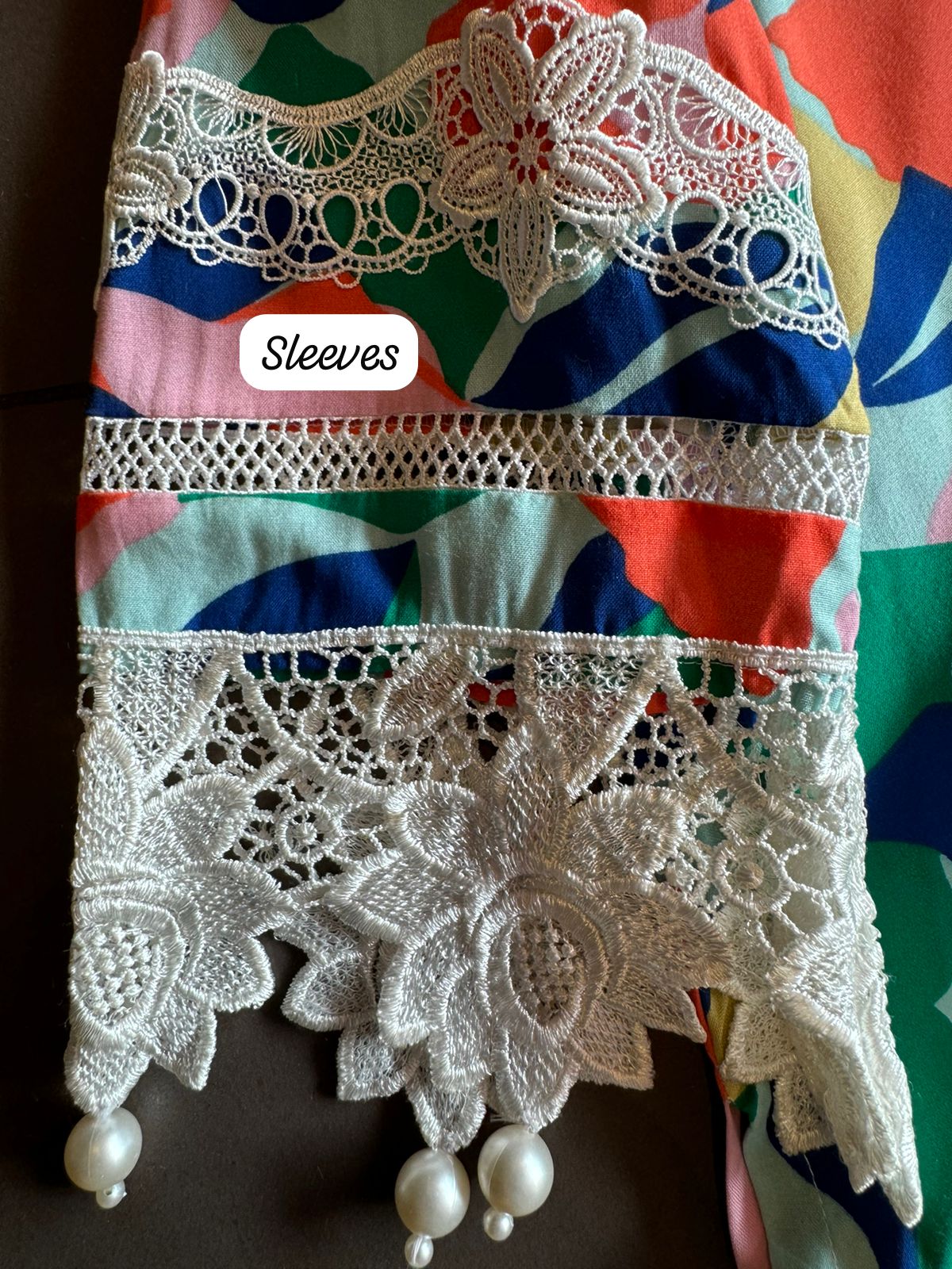 Multi coloured Satya Paul inspired print on Cotton fabric with crochia lace detailings concept with pearl latkans attached on the ghera and sleeves as well