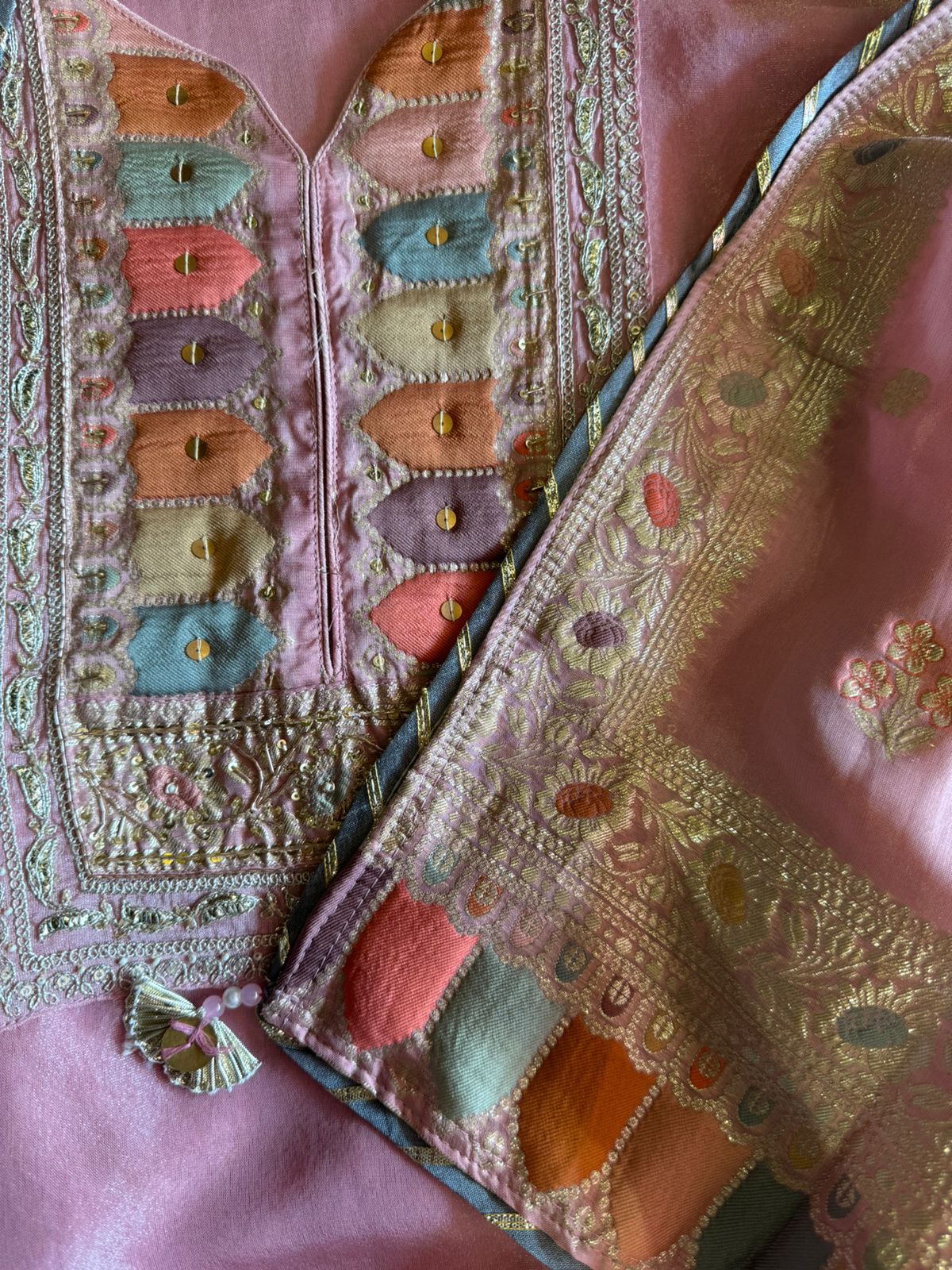 Shimmer tissue Unstitched Shirt with Sabyasachi inspired Neckline and Saaman Colourful cushioned pattern with sequence and Dori work detailings.