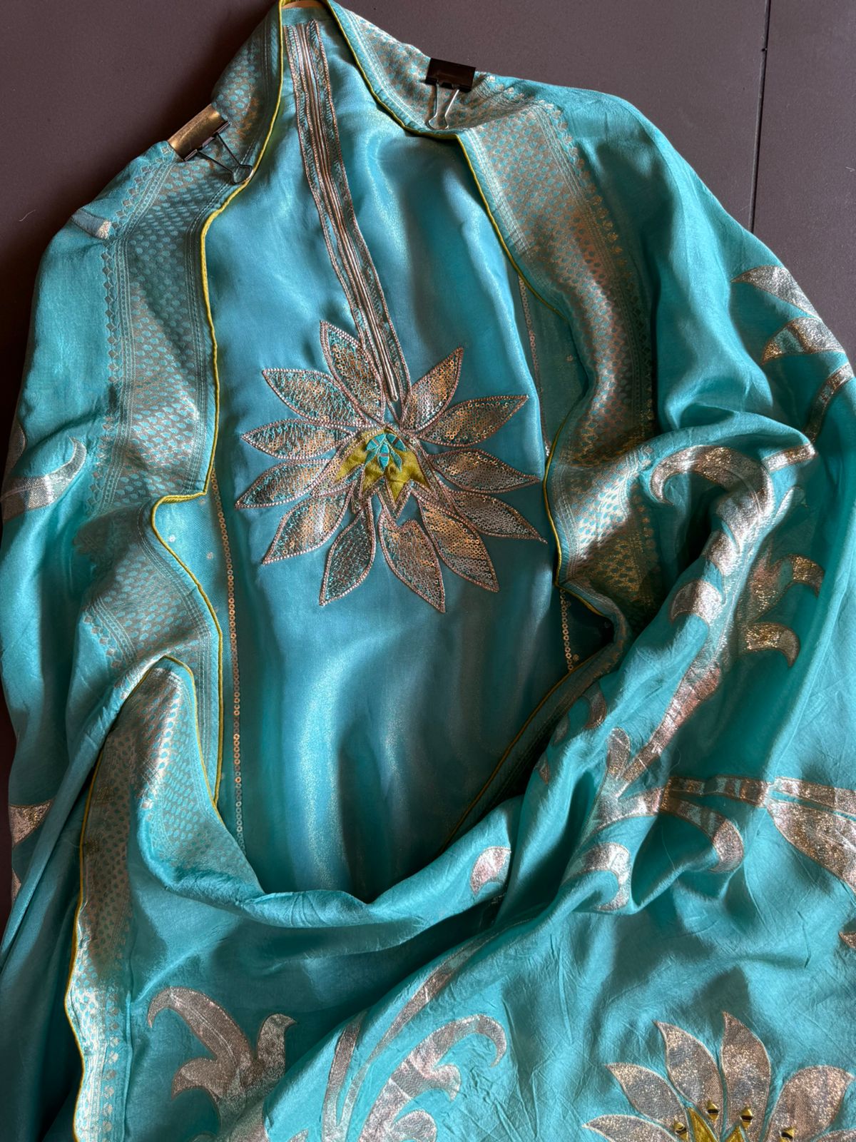 Pure Shimmer Tissue Unstitched Shirt with designer neckline with gotta Detailimgs and A flower design on the neck front with sequence and thread work done.