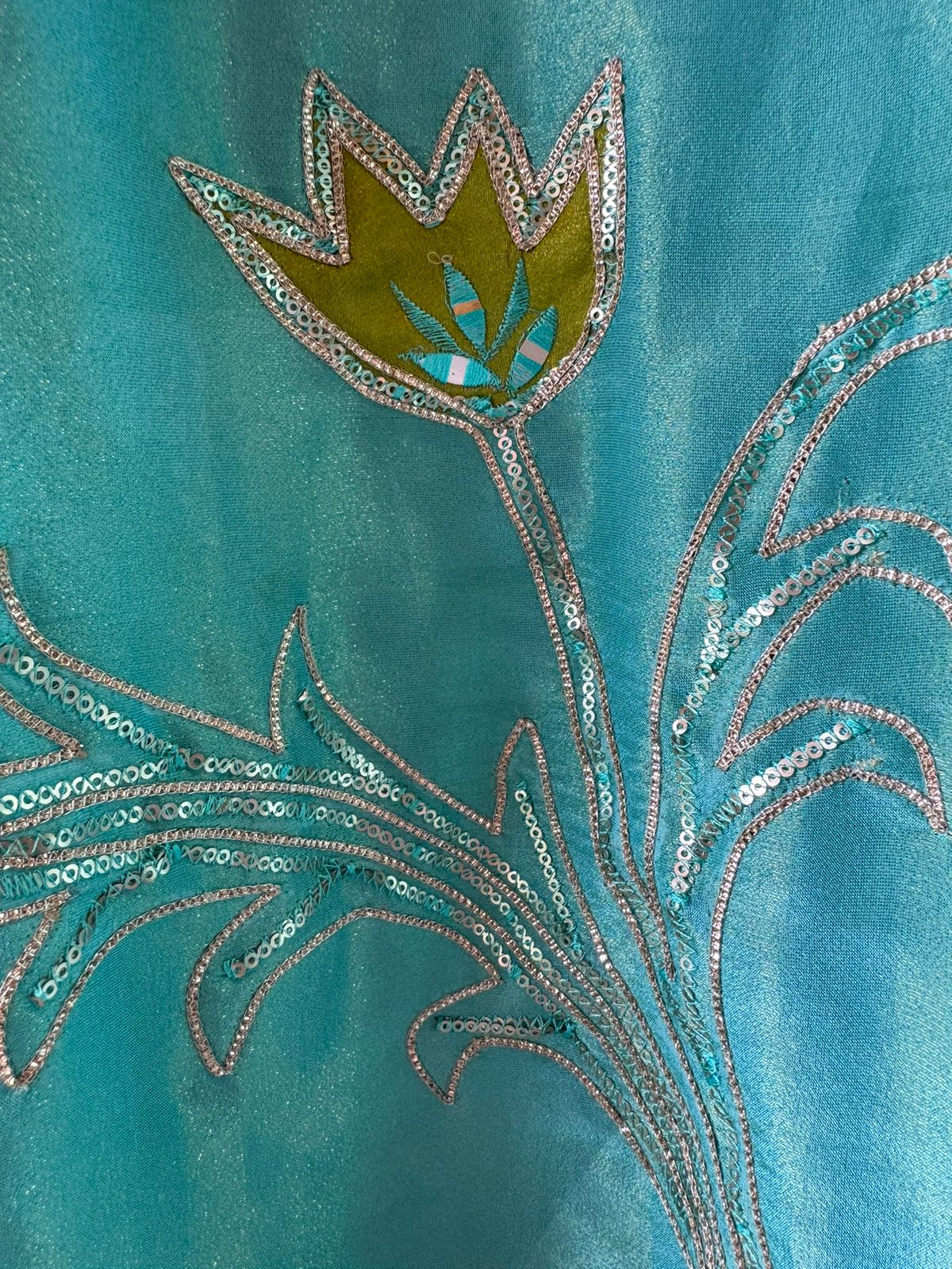 Pure Shimmer Tissue Unstitched Shirt with designer neckline with gotta Detailimgs and A flower design on the neck front with sequence and thread work done.