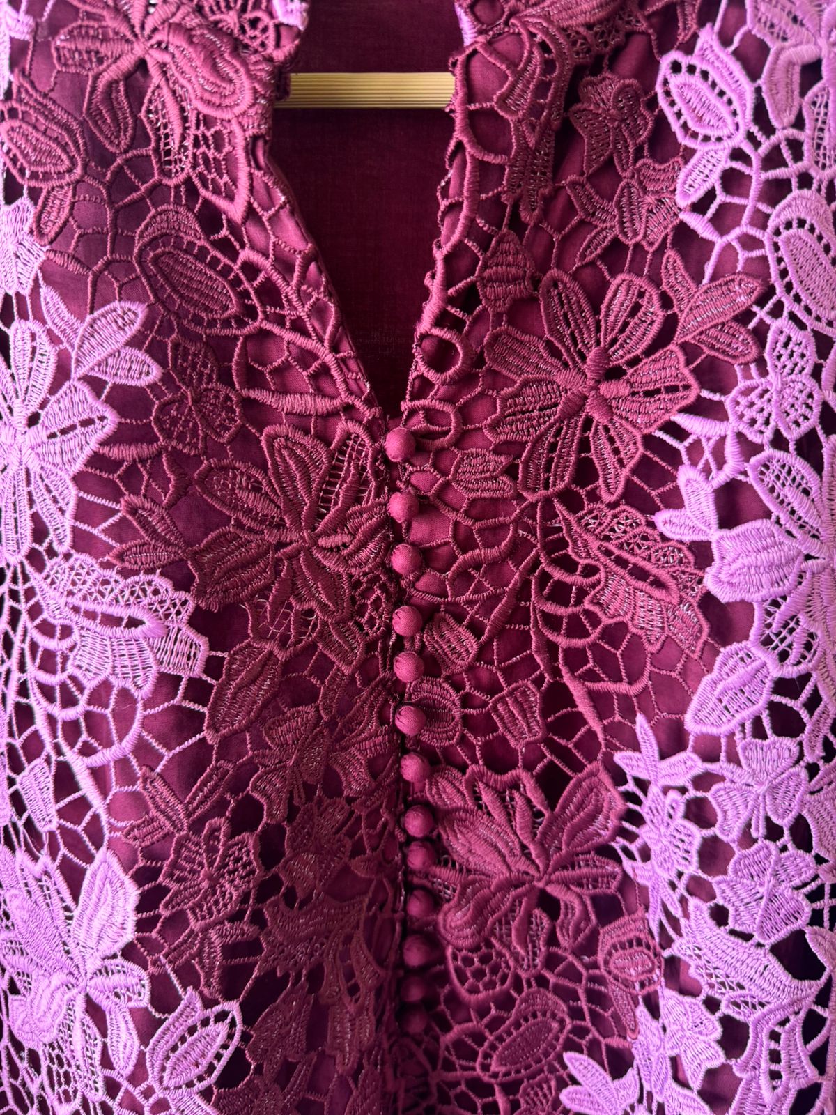 The outfit in the image features a beautiful, intricate lace fabric