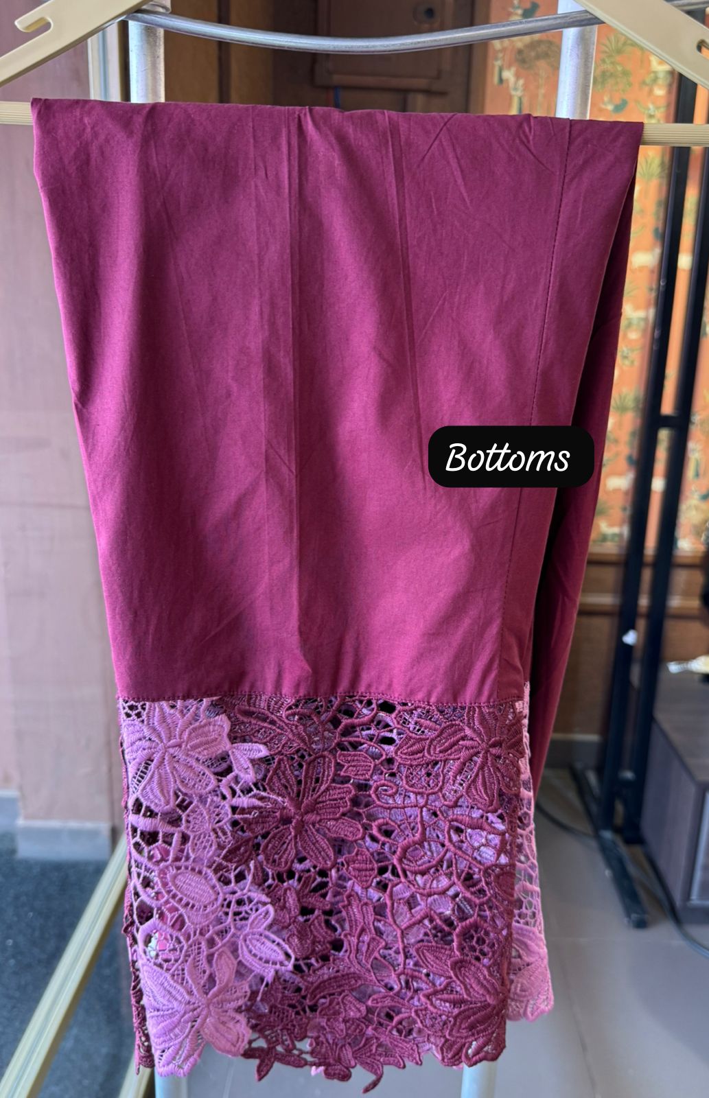 The outfit in the image features a beautiful, intricate lace fabric