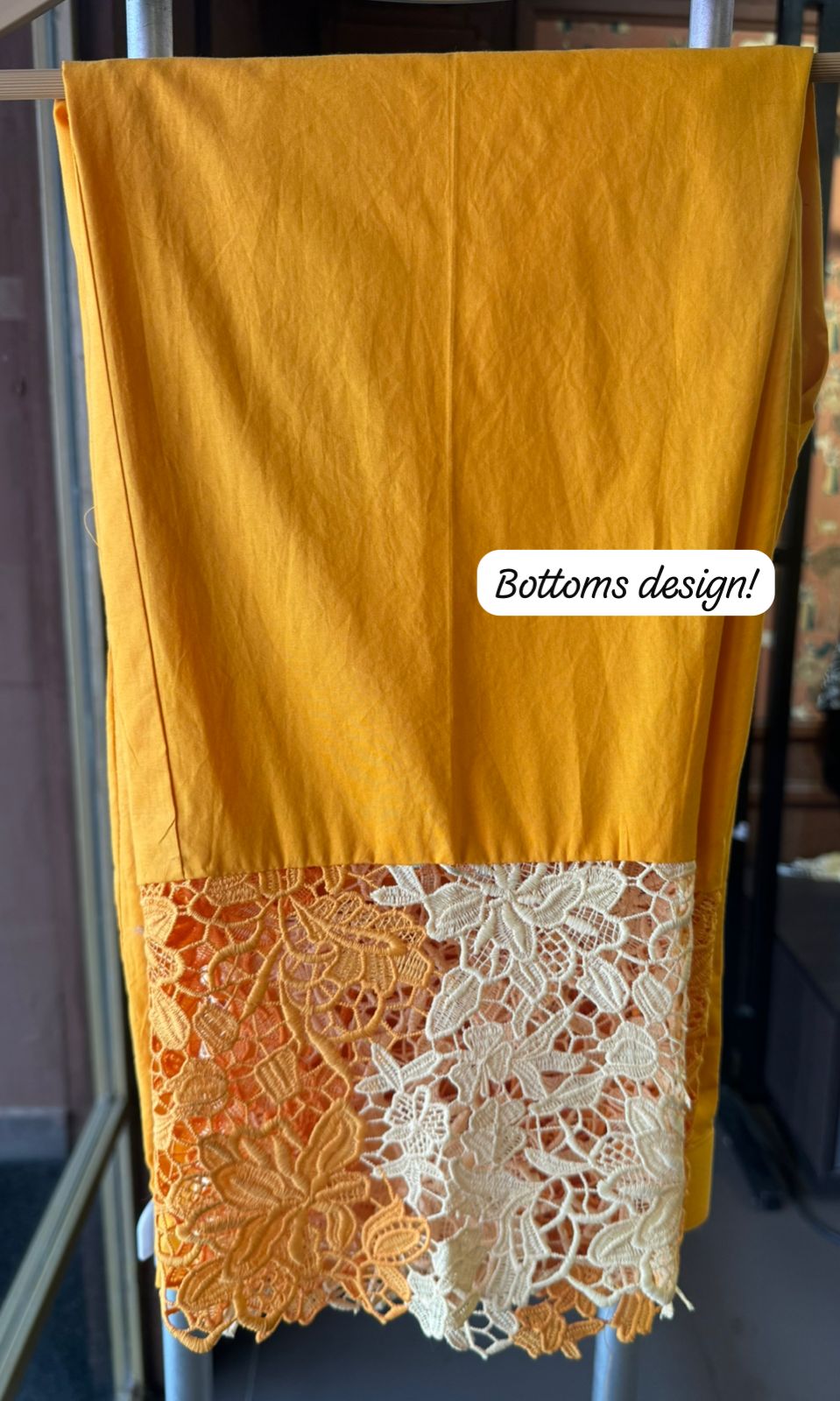 The outfit in the image features a beautiful, intricate lace fabric