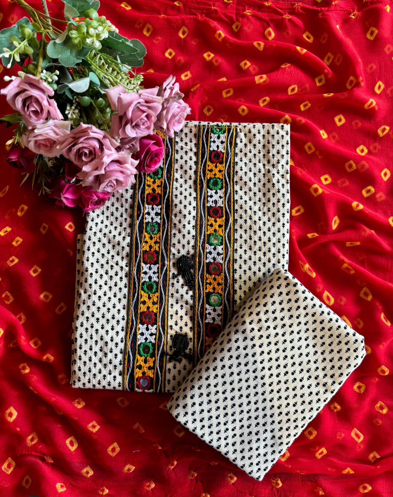 The fabric in the image is a traditional and vibrant unstitched dress