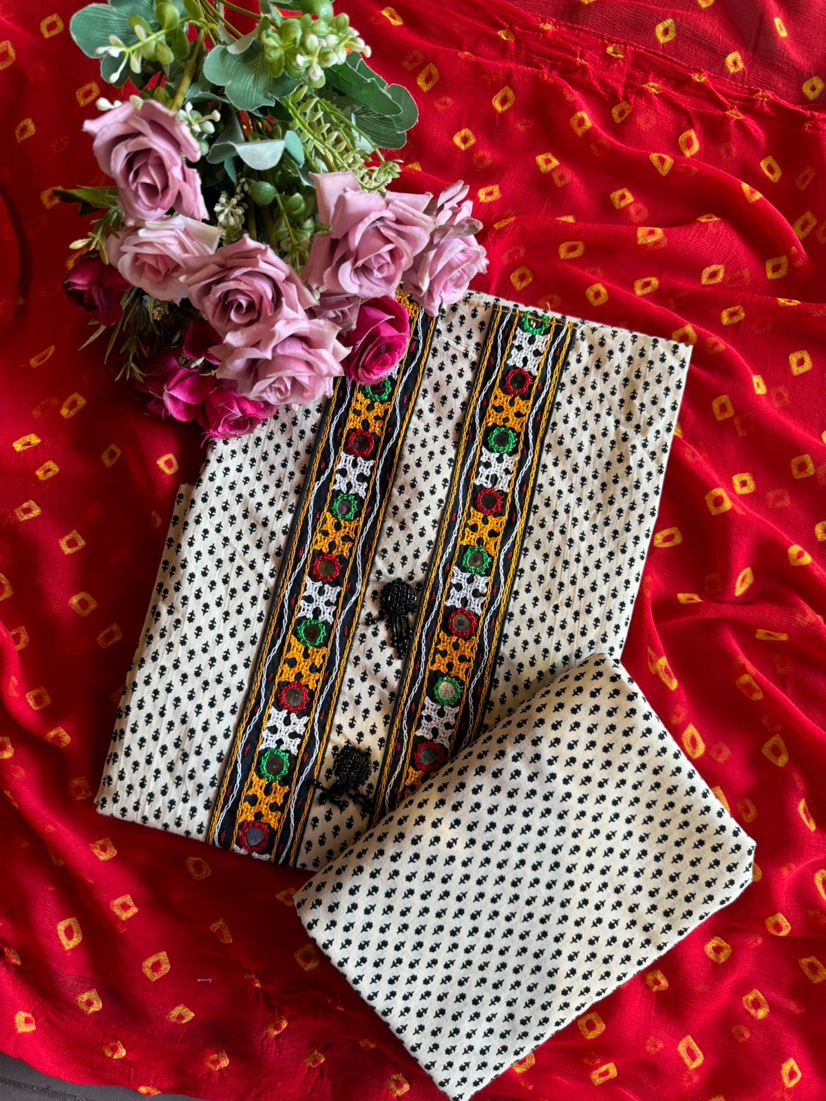 The fabric in the image is a traditional and vibrant unstitched dress