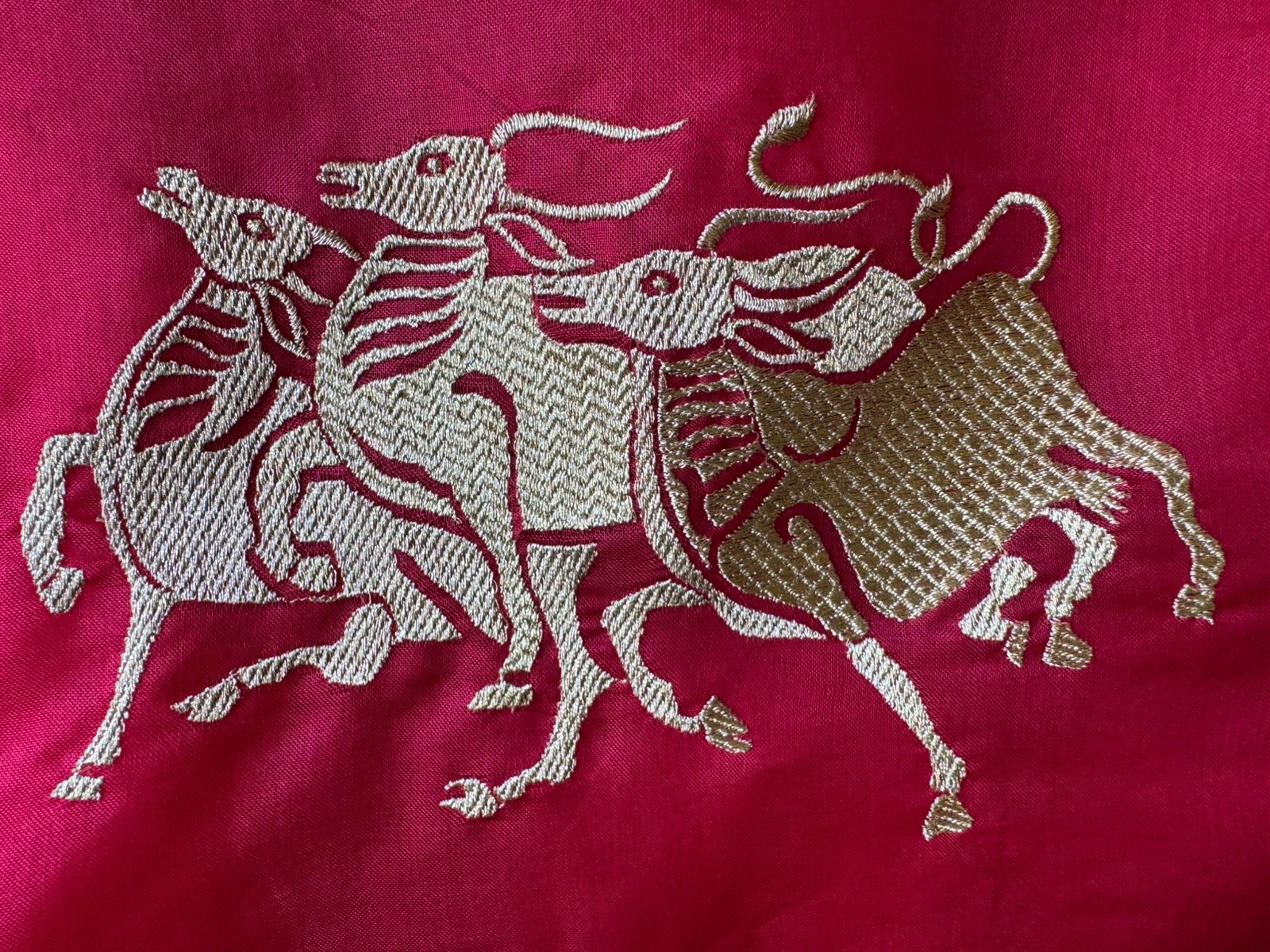 Dancing horse motifs, executed in golden zari