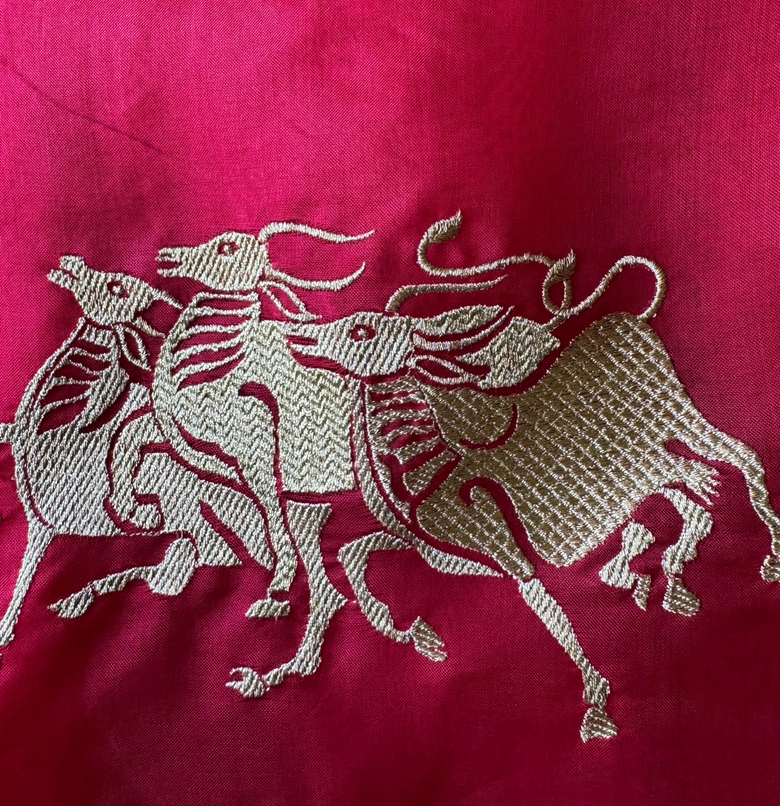 Dancing horse motifs, executed in golden zari