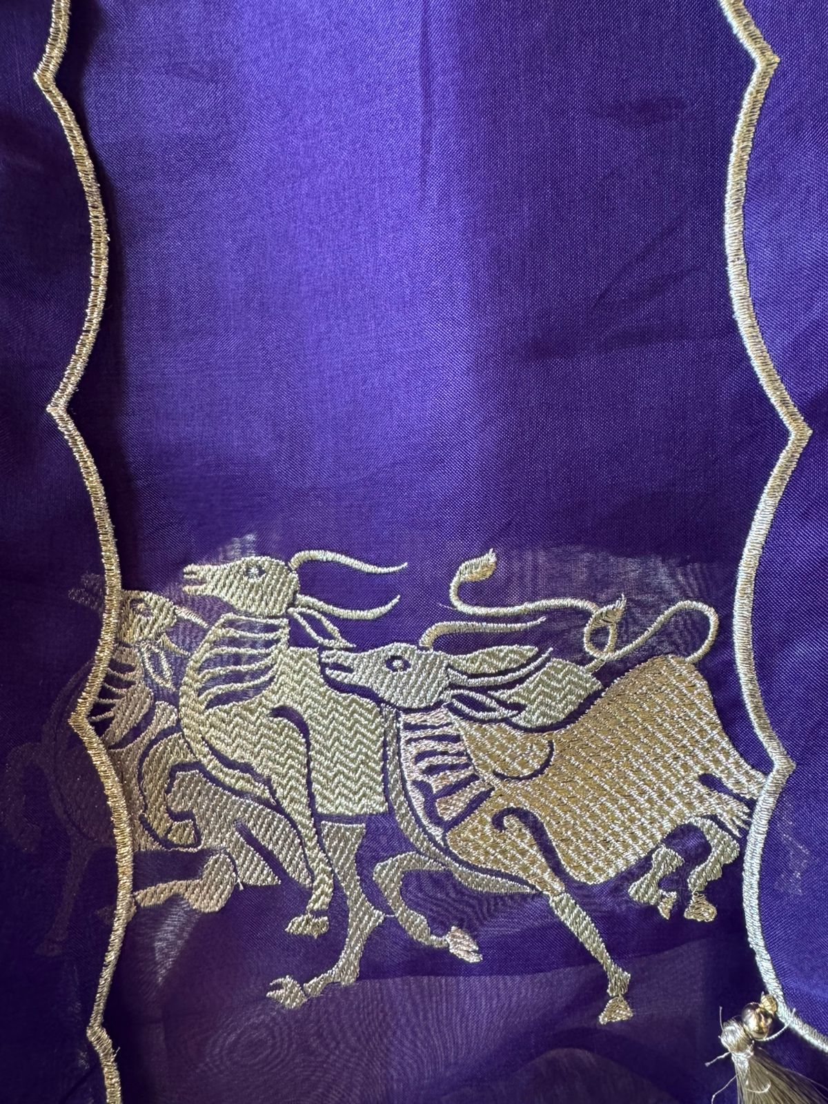 Dancing horse motifs, executed in golden zari