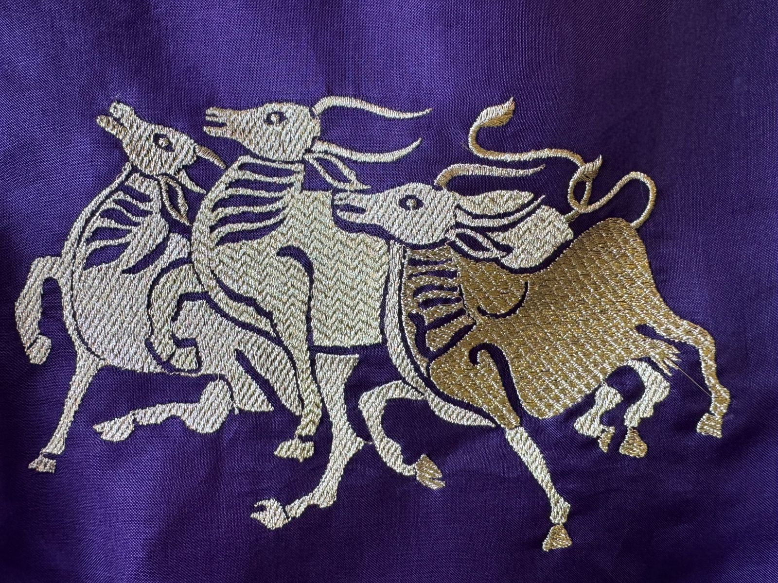 Dancing horse motifs, executed in golden zari