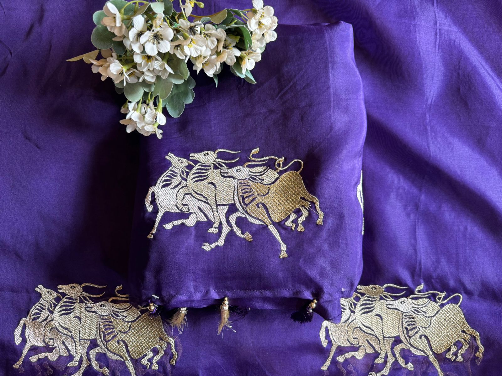 Dancing horse motifs, executed in golden zari