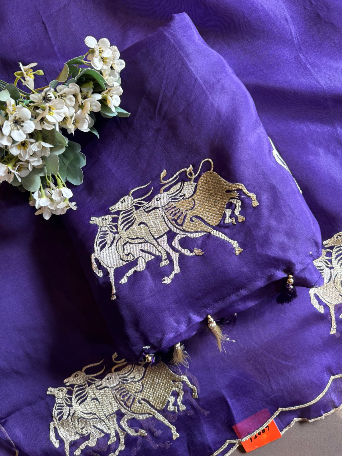 Dancing horse motifs, executed in golden zari