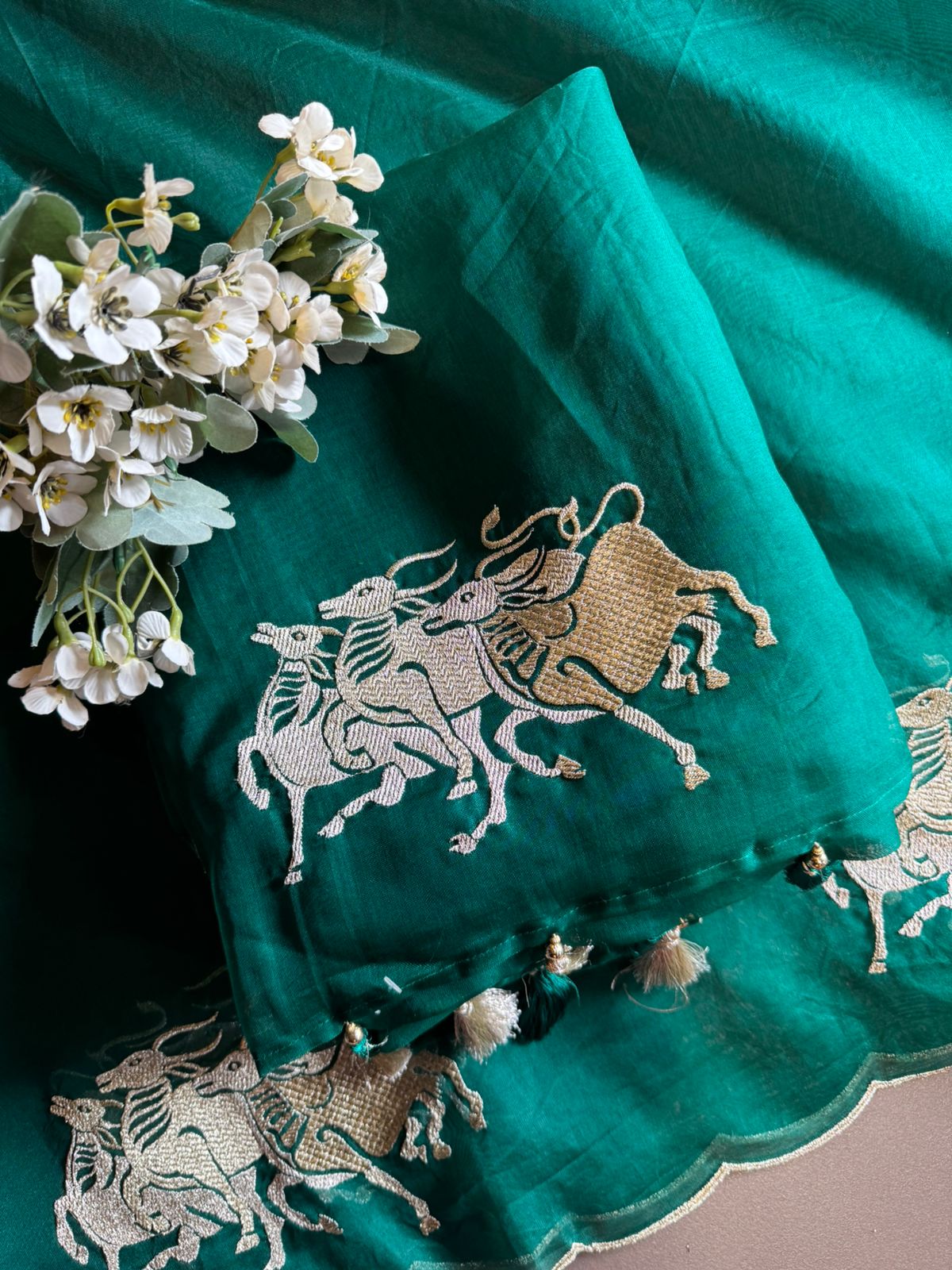 Dancing horse motifs, executed in golden zari