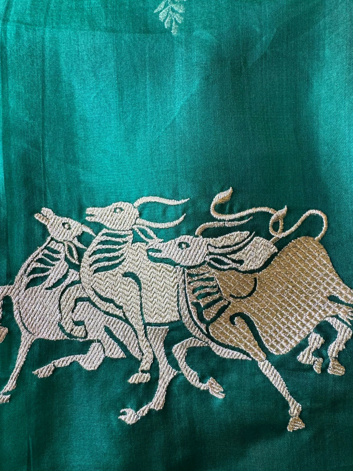 Dancing horse motifs, executed in golden zari