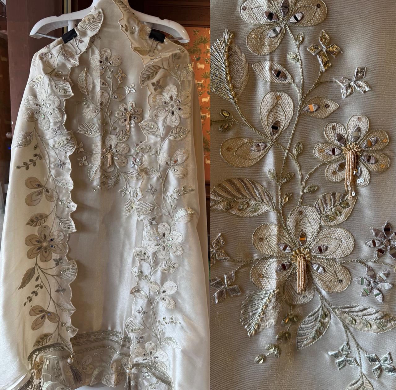 Ivory-beige base with heavy floral and leaf embroidery