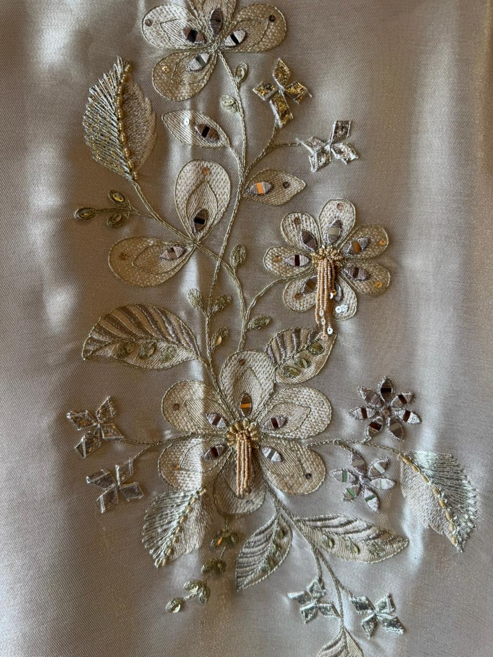 Ivory-beige base with heavy floral and leaf embroidery