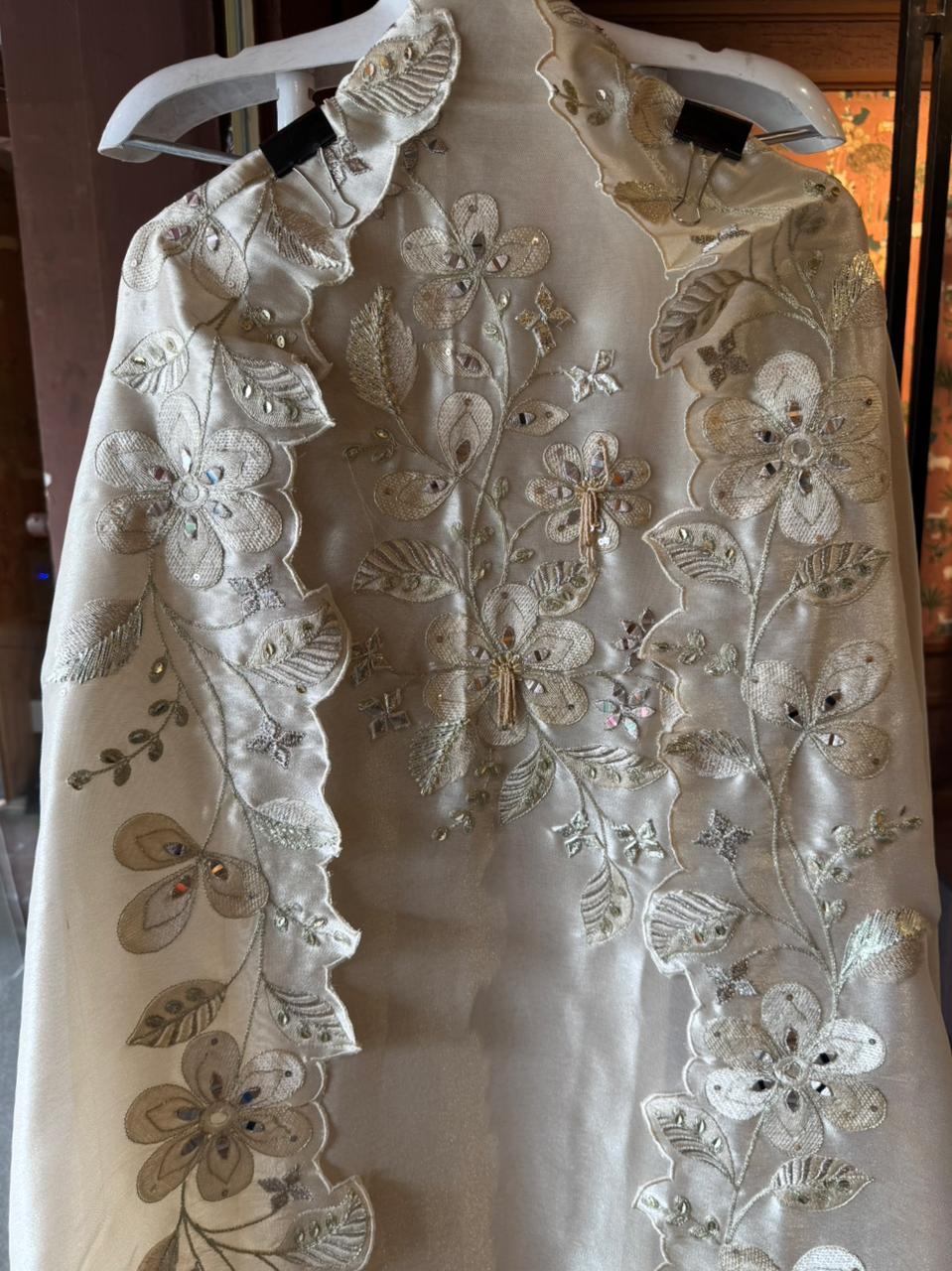 Ivory-beige base with heavy floral and leaf embroidery