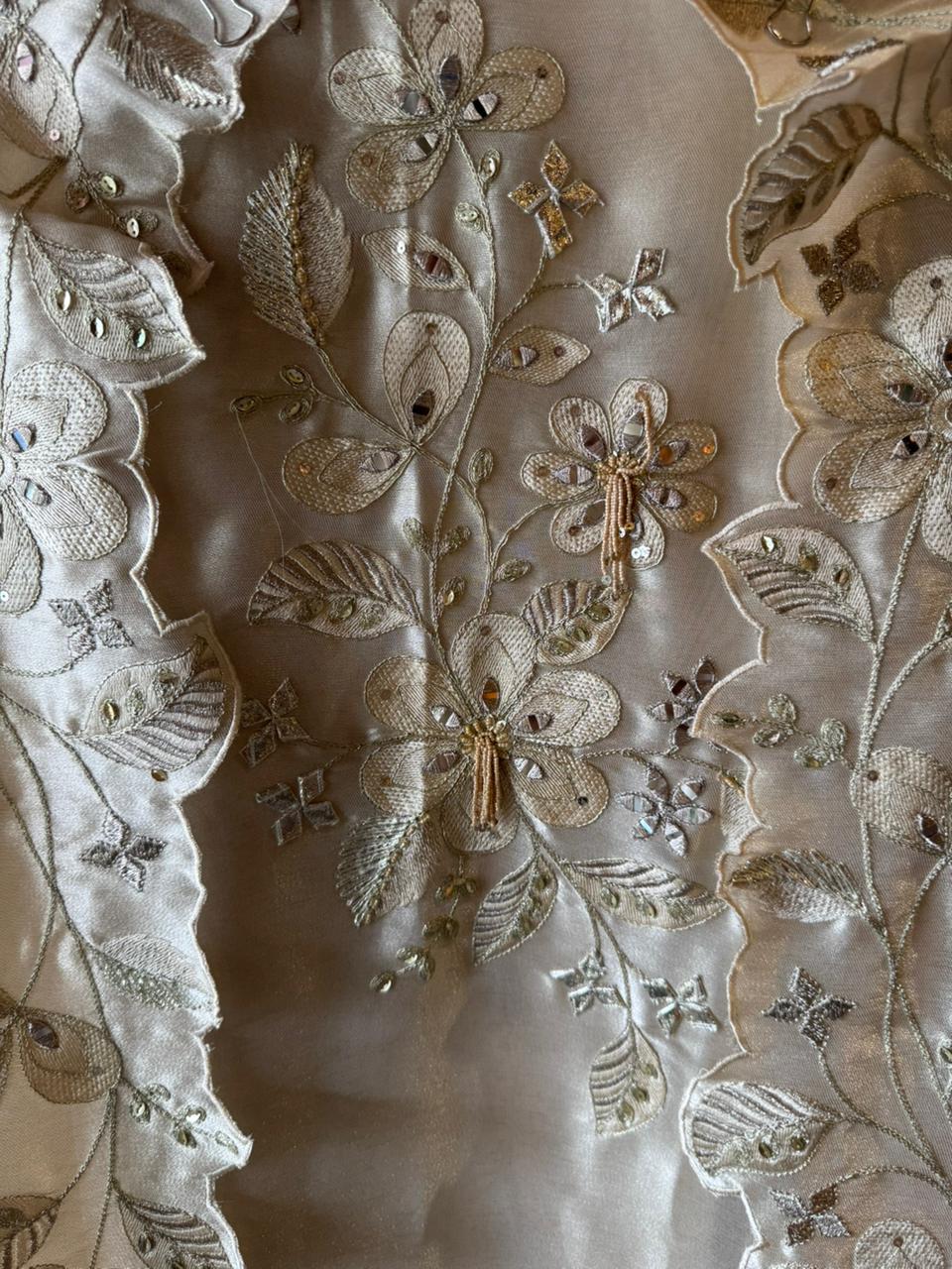 Ivory-beige base with heavy floral and leaf embroidery