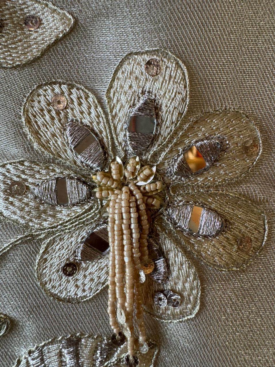 Ivory-beige base with heavy floral and leaf embroidery