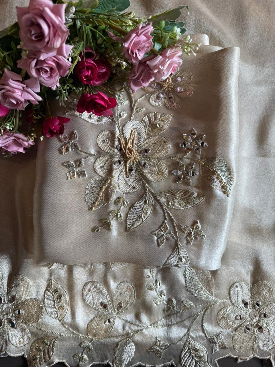 Ivory-beige base with heavy floral and leaf embroidery