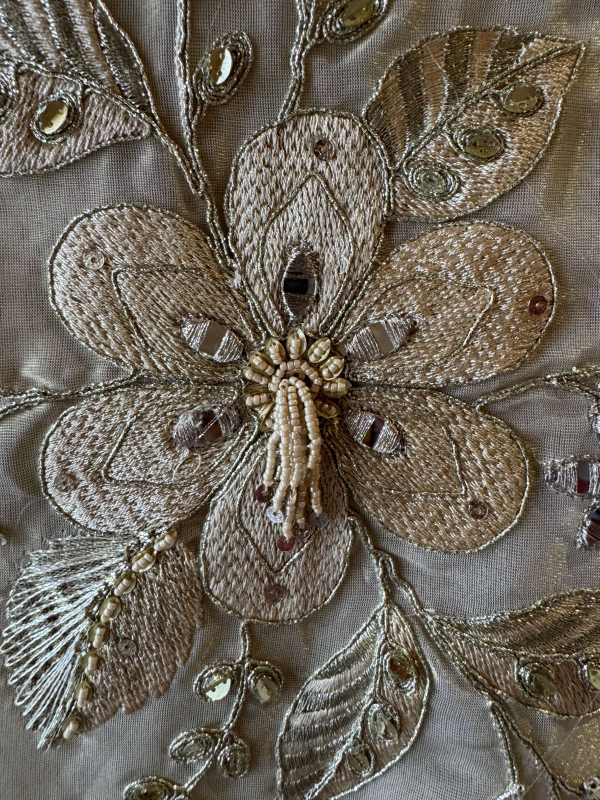 Ivory-beige base with heavy floral and leaf embroidery