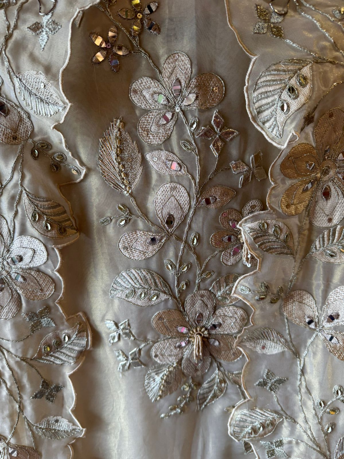 Ivory-beige base with heavy floral and leaf embroidery