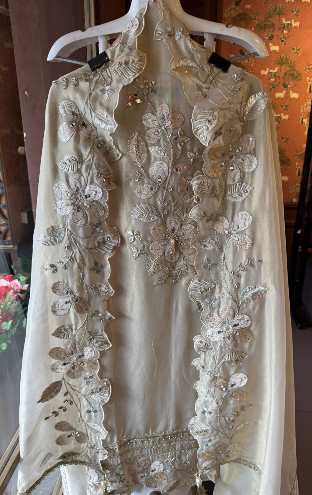 Ivory-beige base with heavy floral and leaf embroidery