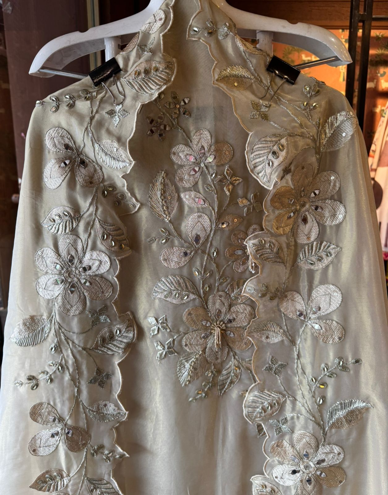 Ivory-beige base with heavy floral and leaf embroidery