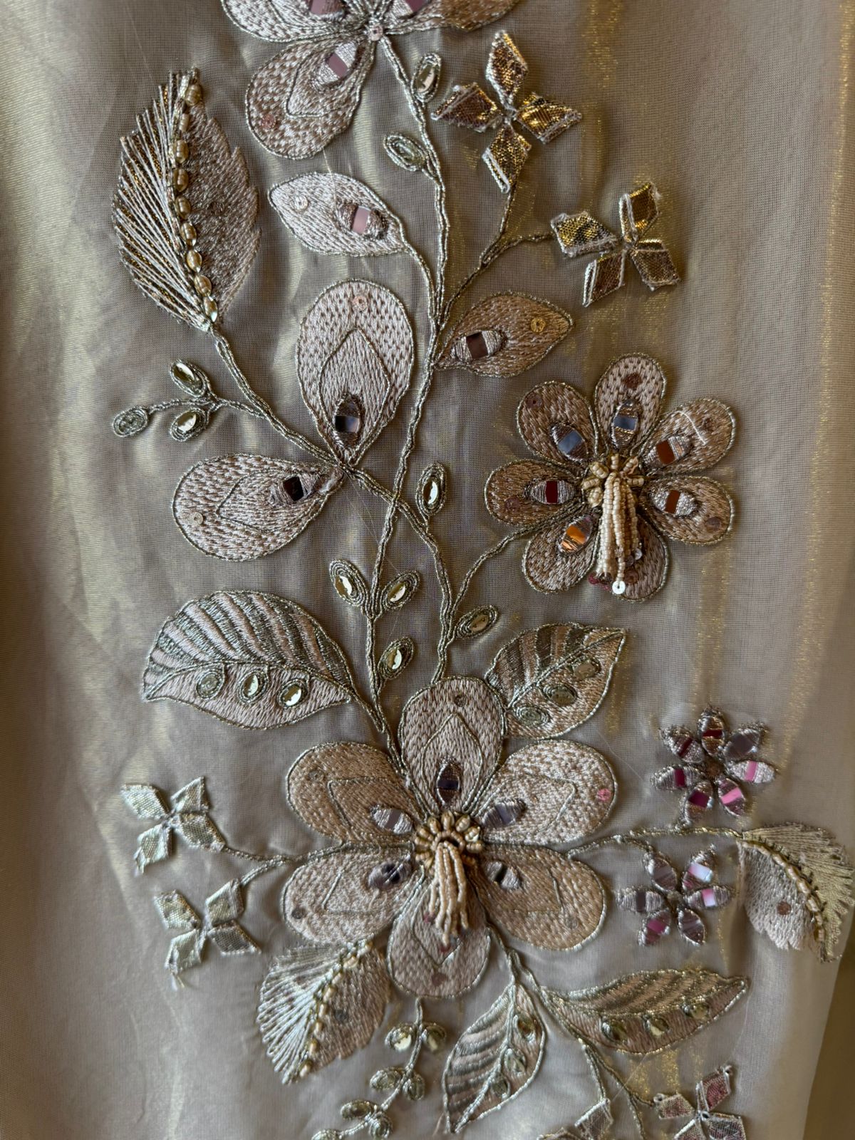 Ivory-beige base with heavy floral and leaf embroidery