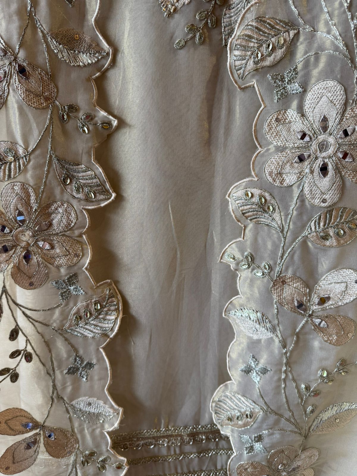 Ivory-beige base with heavy floral and leaf embroidery