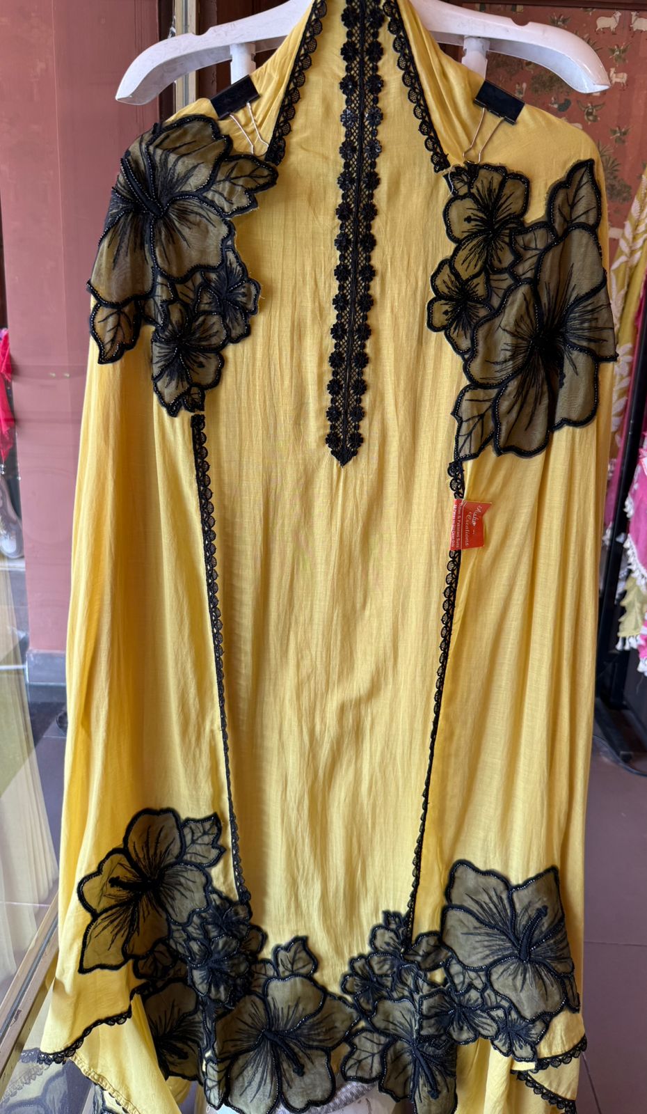 Graceful ensemble featuring large floral appliqué work with delicate thread