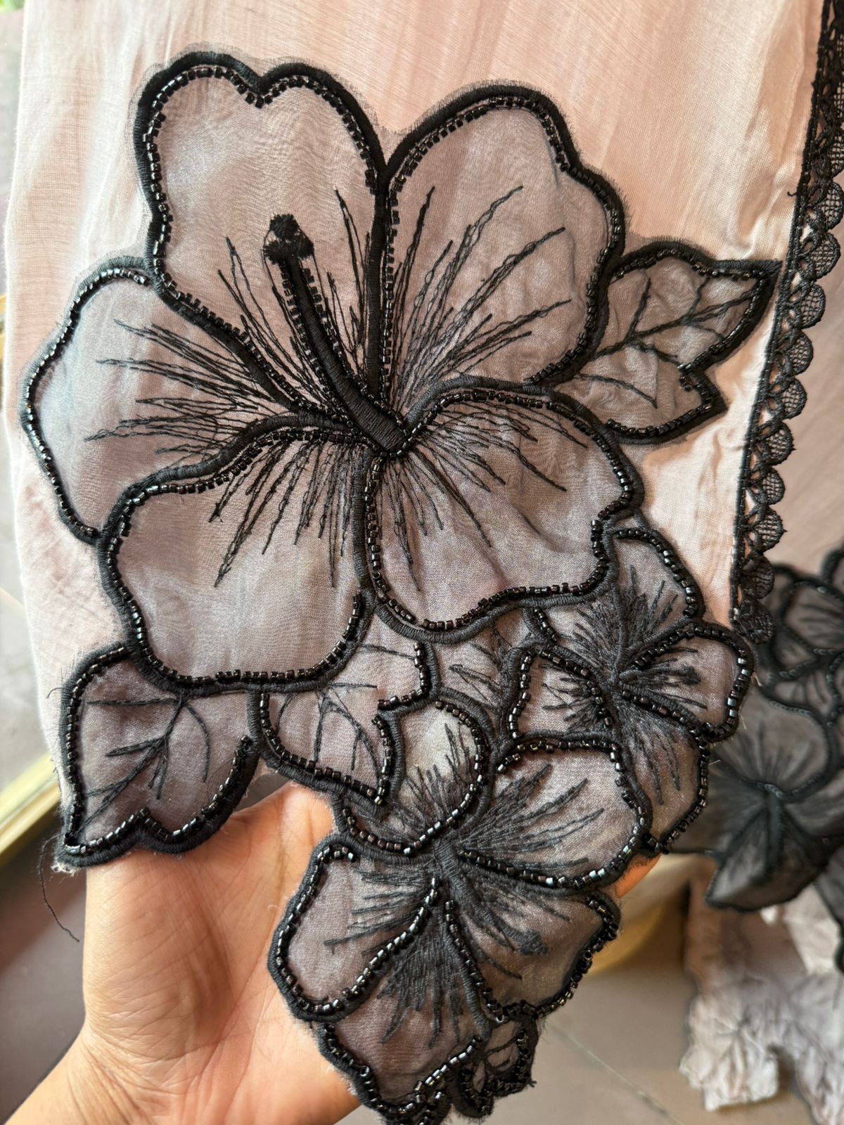 Graceful ensemble featuring large floral appliqué work with delicate thread