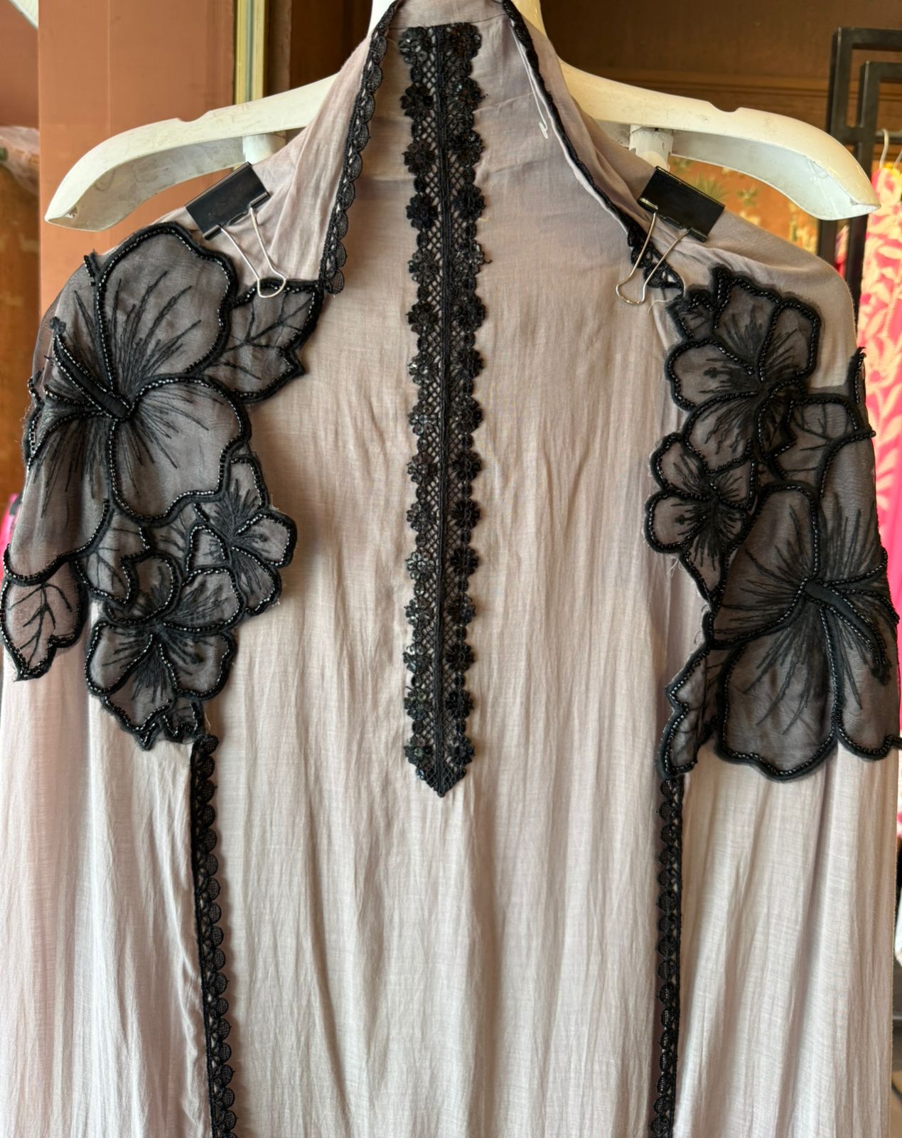 Graceful ensemble featuring large floral appliqué work with delicate thread
