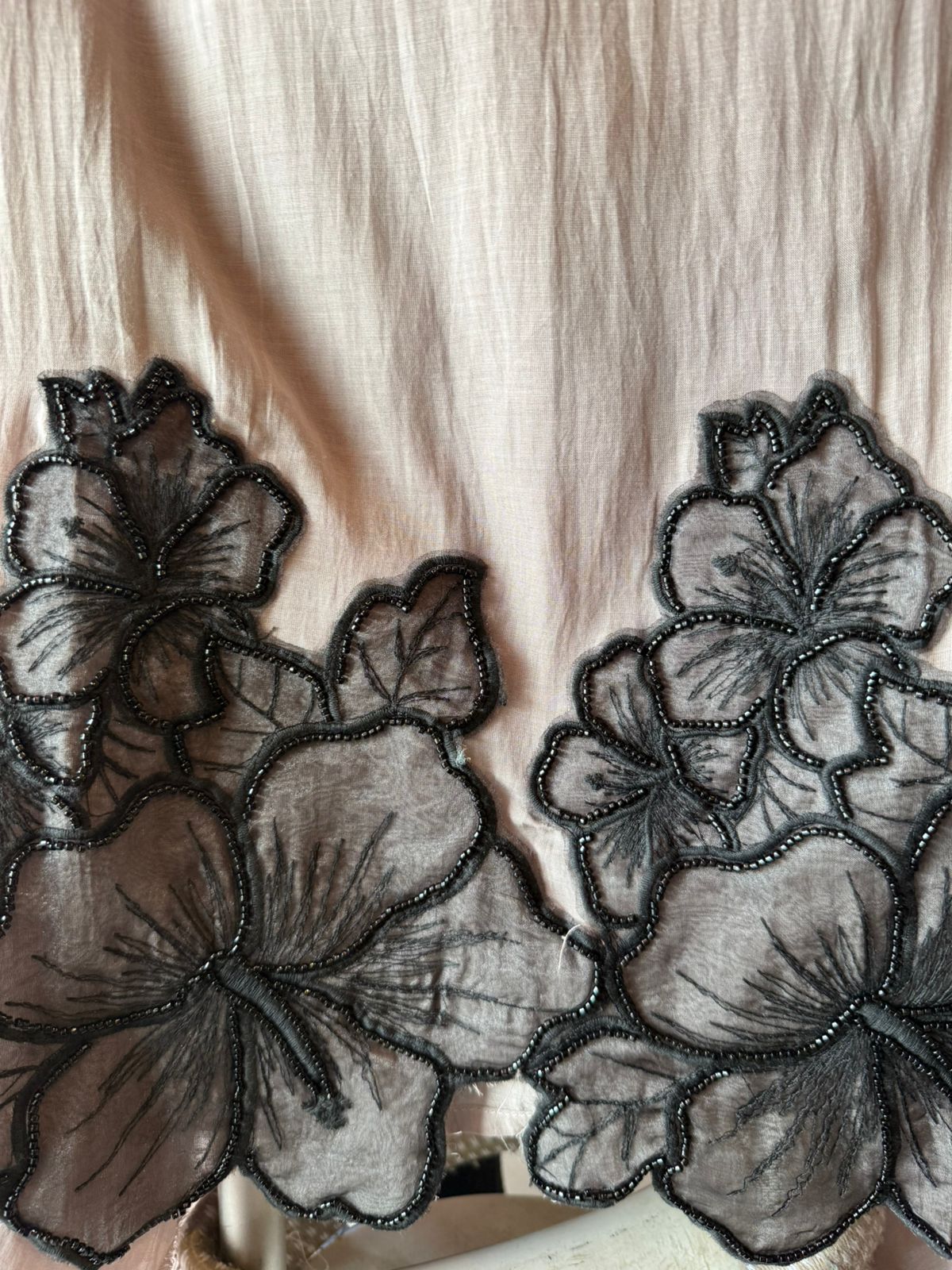 Graceful ensemble featuring large floral appliqué work with delicate thread