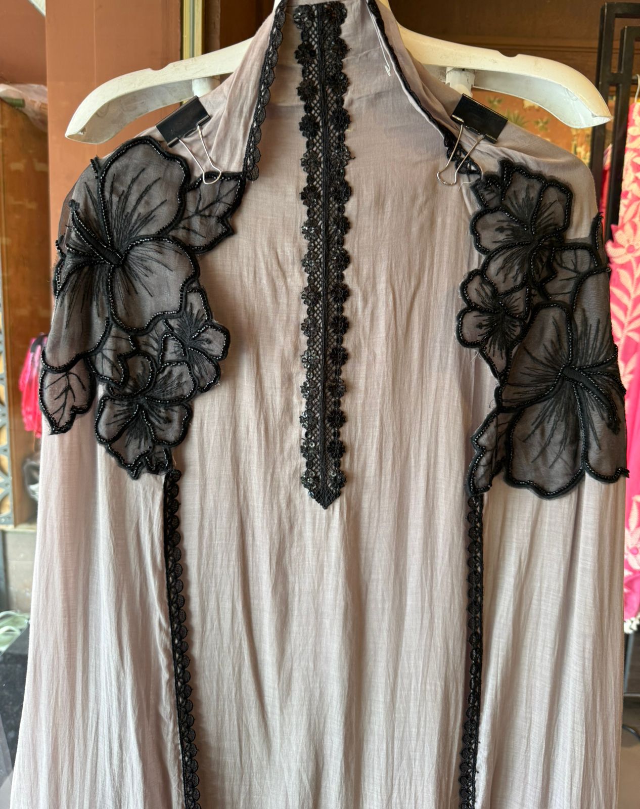 Graceful ensemble featuring large floral appliqué work with delicate thread